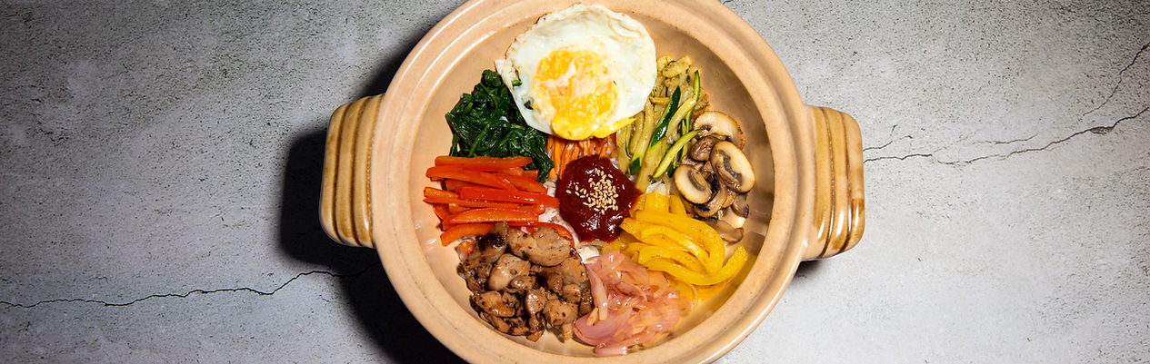 Chicken bibimbap served in a stone bowl
